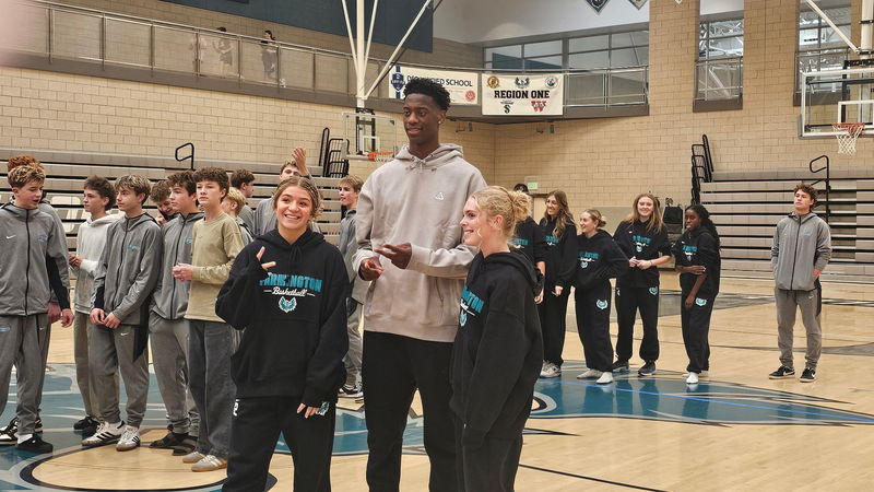 AJ taking photos with students