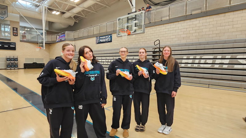 Girls team showing off their new shoes