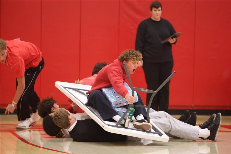 Student wearing red sitting on a table