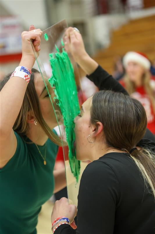 Students licking frosting off plexiglass