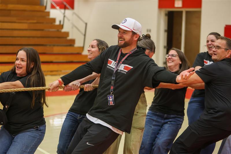 teachers smiling after winning tug of war