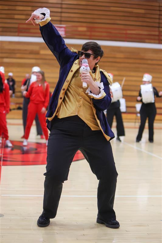 teacher singing into a mic for a lip sync battle