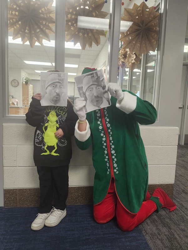 Pinky & a student with faces covered with copies