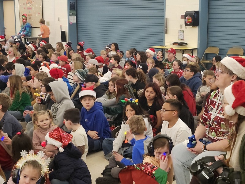 Kids sitting in the gym for the christmas sing-along.