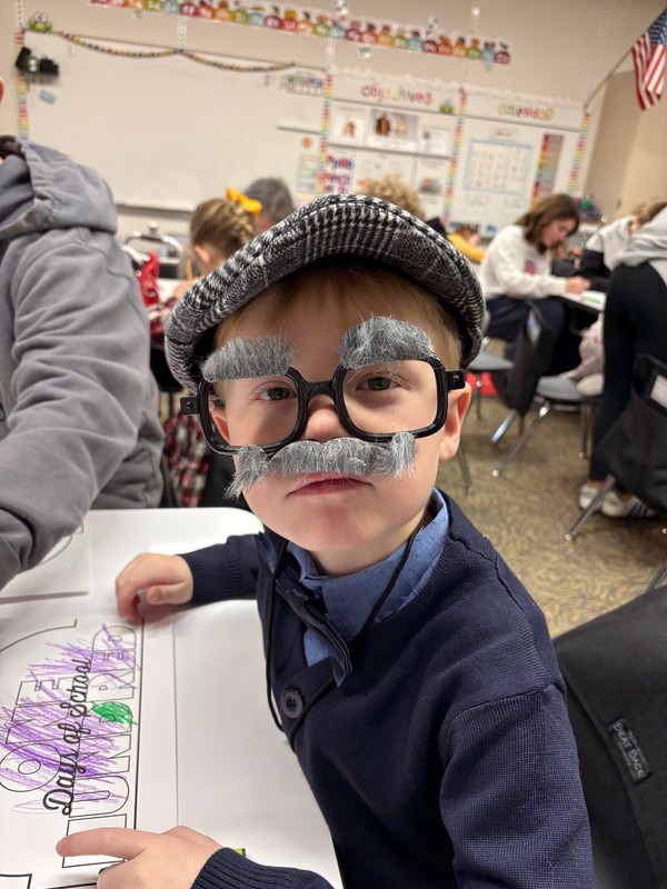 Student dressed as a 100 year old in a classroom