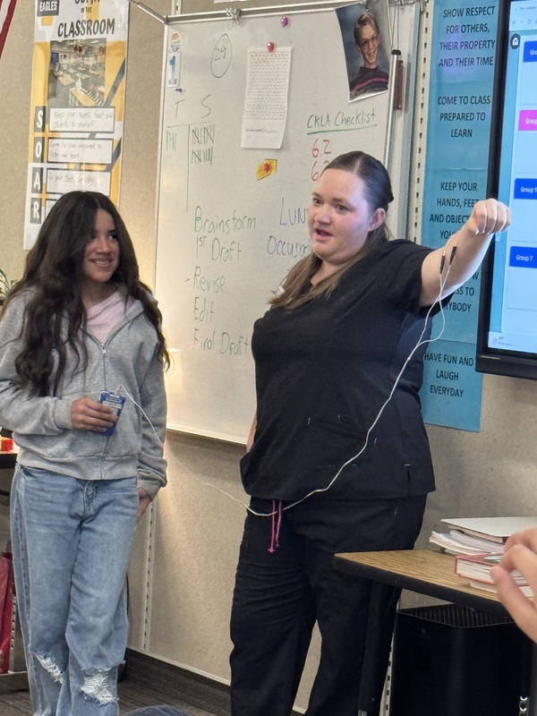 Student doing a demonstration with an occupational therapist.
