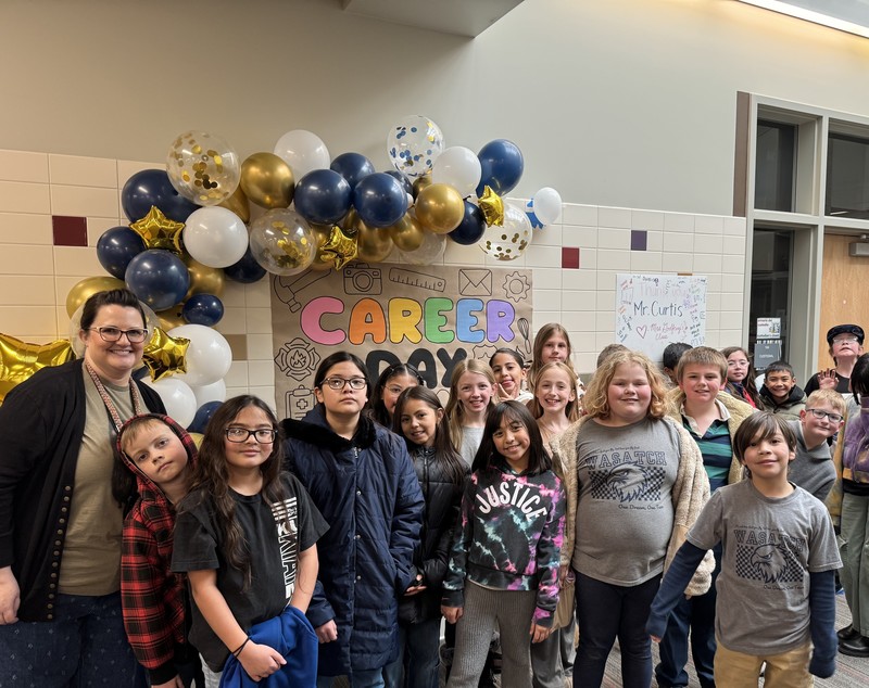 A class standing in front of a Career Day poster.