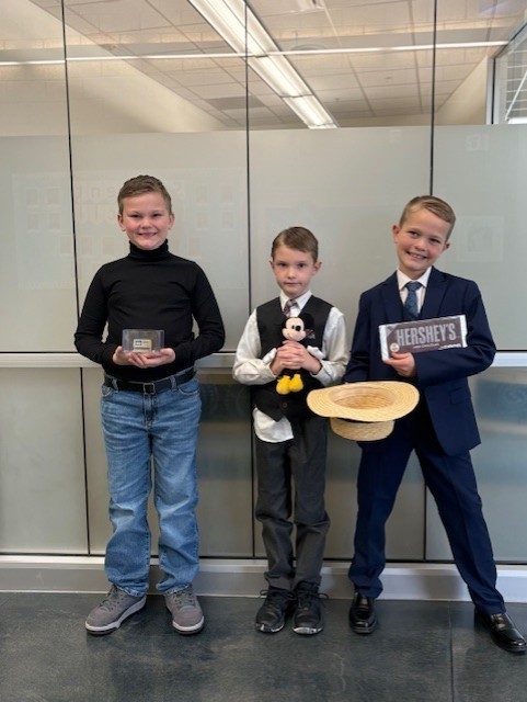 Students dressed in costume as historical figures with hat and stuffed animal.