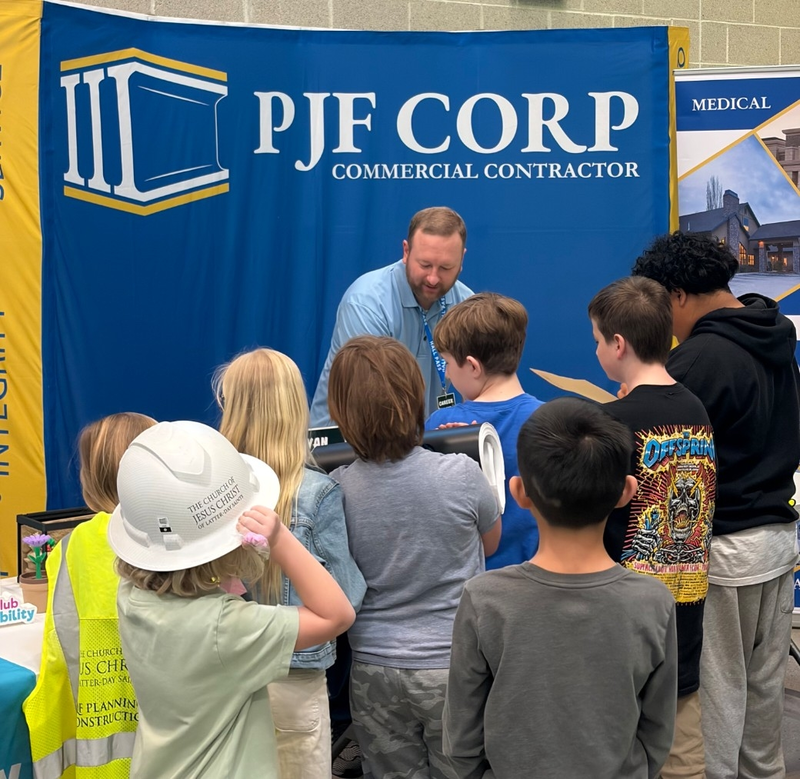 Bountiful Elementary students surround Ryan Barton to ask questions during Career Fair.