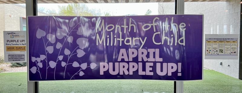 Poster hanging inside school saying "Month of the Military Child. April Purple Up!