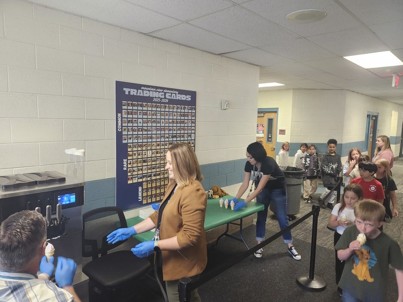 Mr. Nash and others dishing up ice cream cones for students