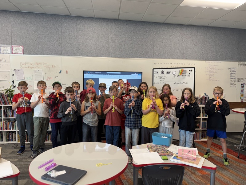 4th grade class posing with their recorders for a picture.