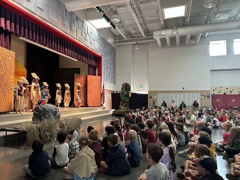Lions in The Lion King Jr. performing on stage.