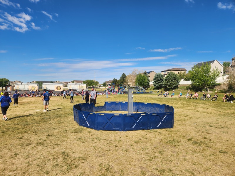 Kickball game on the playground between staff and 6th grade