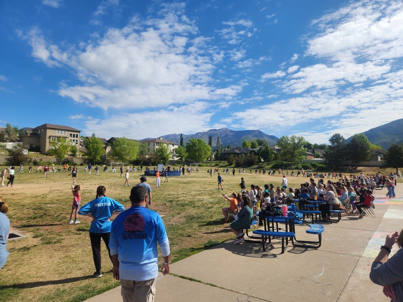Kickball game on the playground between staff and 6th grade