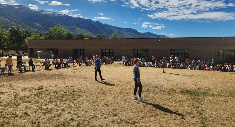 Kickball game on the playground between staff and 6th grade