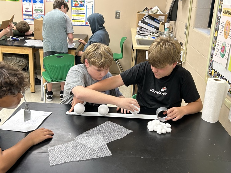 Students creating egg structure