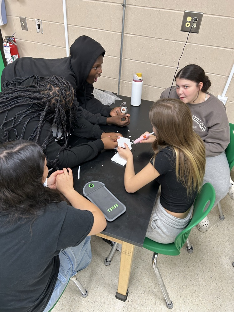 Students creating egg structure