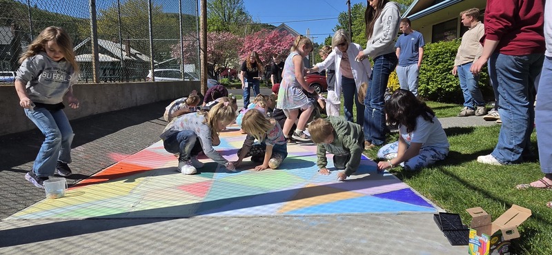 students drawing on the sidewalk