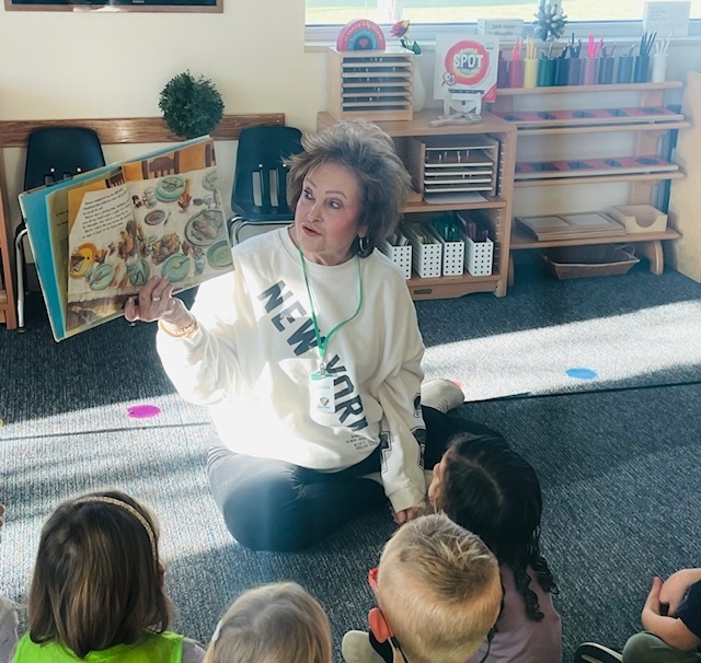 Grandparent reading a story to children