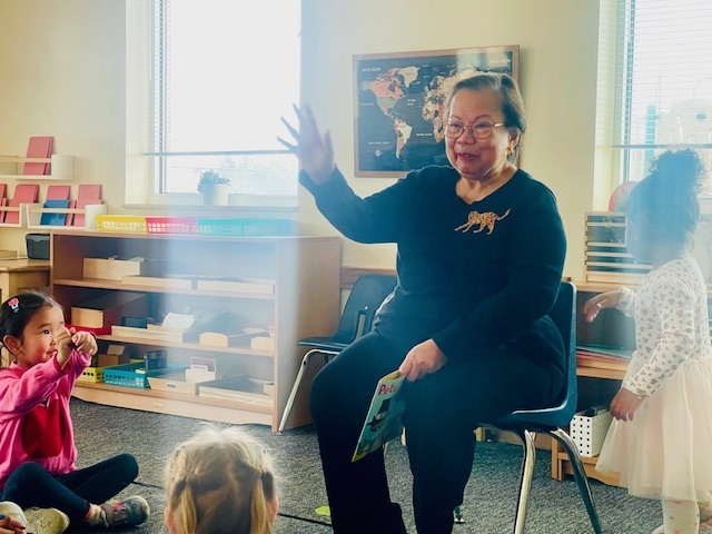 Grandparent reading a story to children