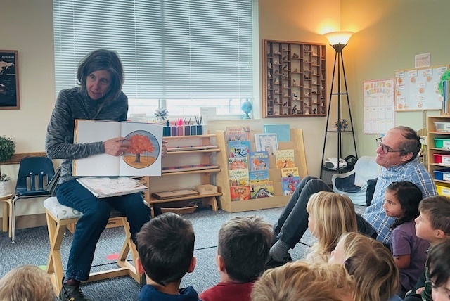 Grandparent reading a story to children