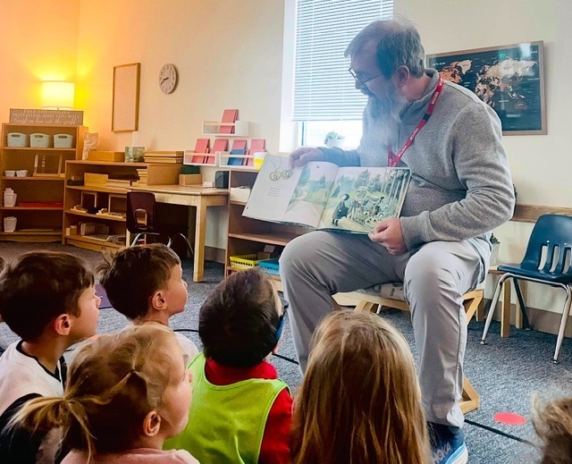 Grandparent reading a story to children