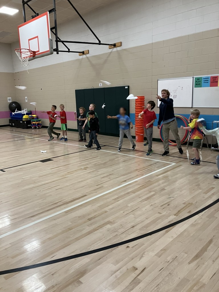 Students flying paper airplanes