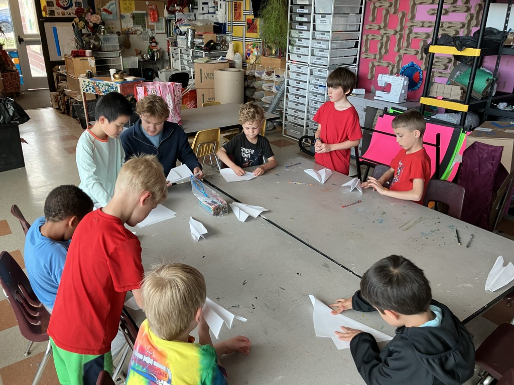 Students making paper airplanes