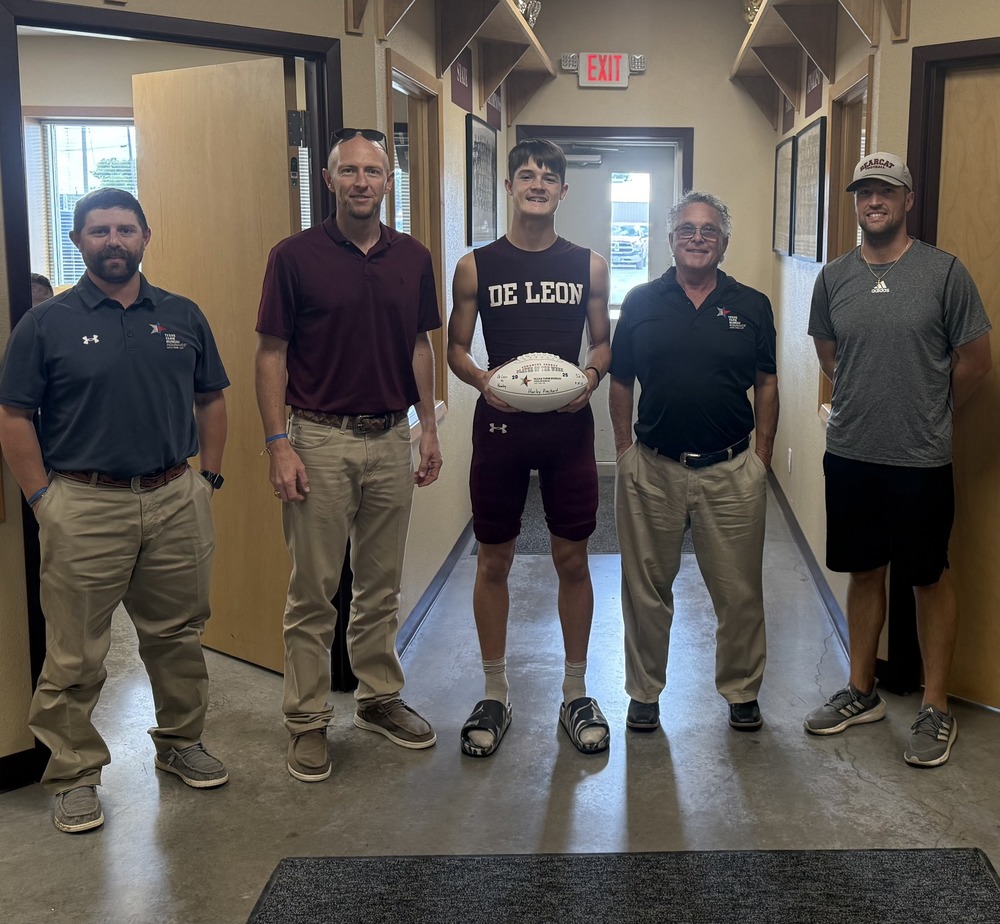 player of the week and four  men standing in field house
