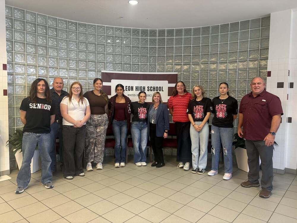 group picture of health science students, teachers and guest speaker in front foyer