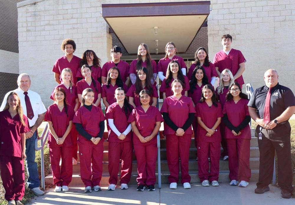 cns and ccma candidates and two teachers group picture in front of high school