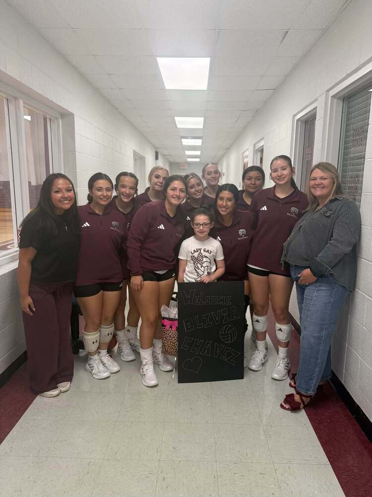 volleyball group picture with younger student and coach