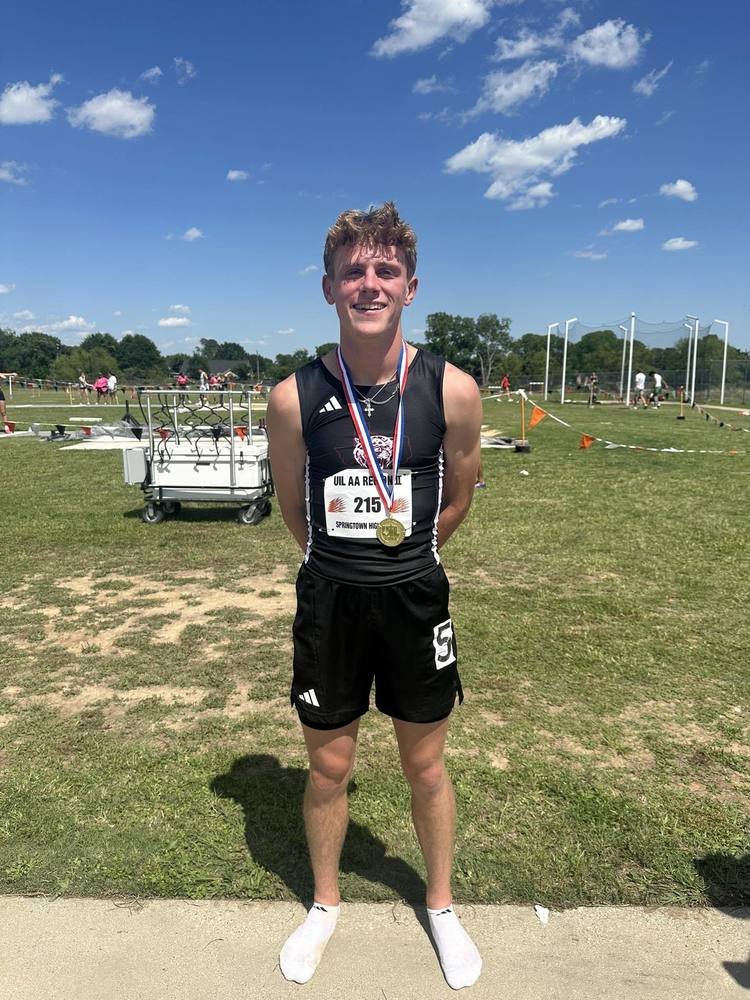 max jones wearing his gold medal at regional track meet
