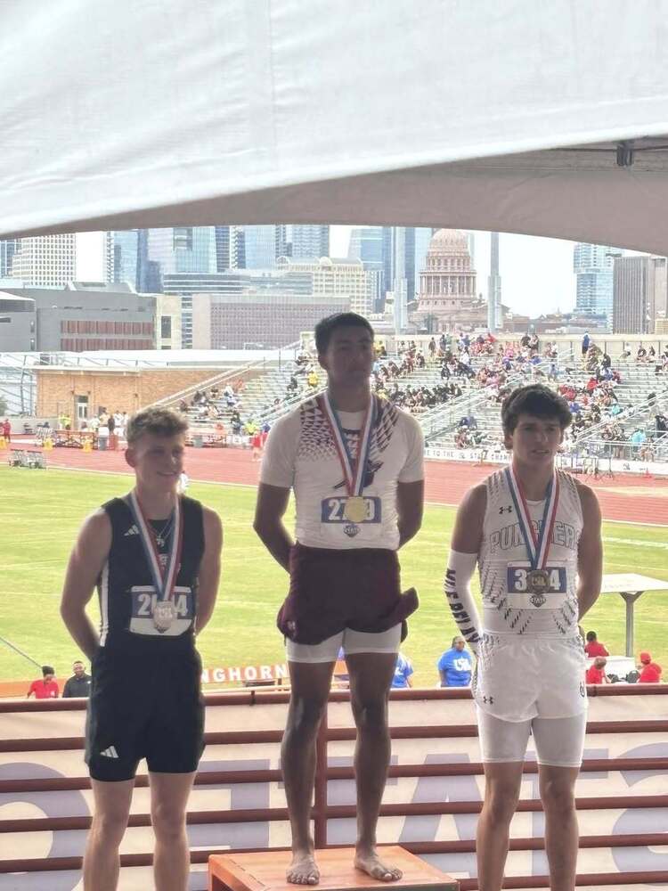 silver medalist max jones with first place and third place winners standing on podium