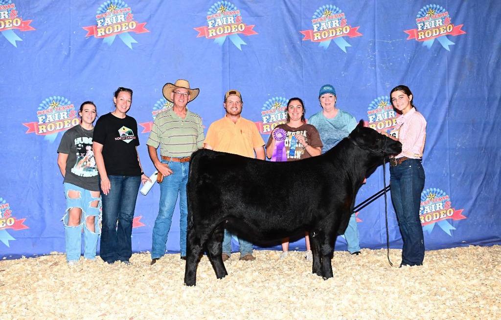 ffa student posing with calf and her family