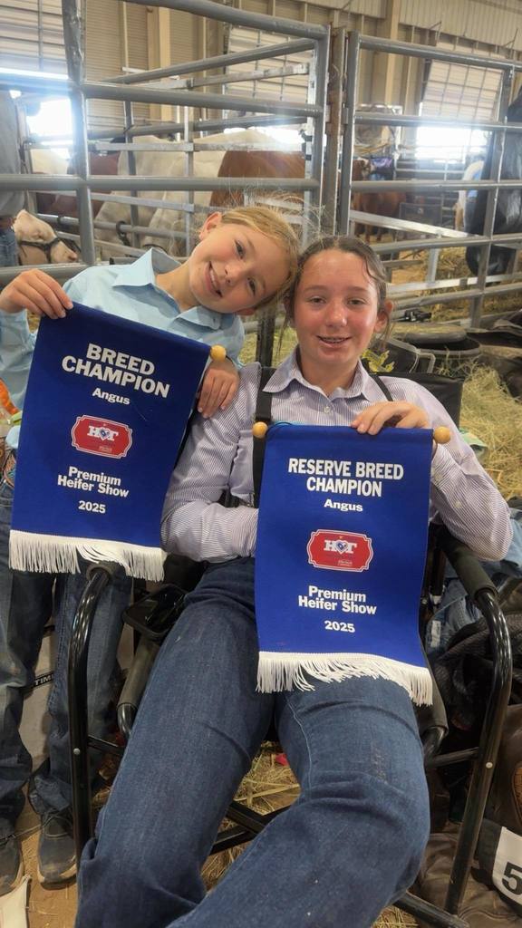 two ffa members holding winning banners at stock show