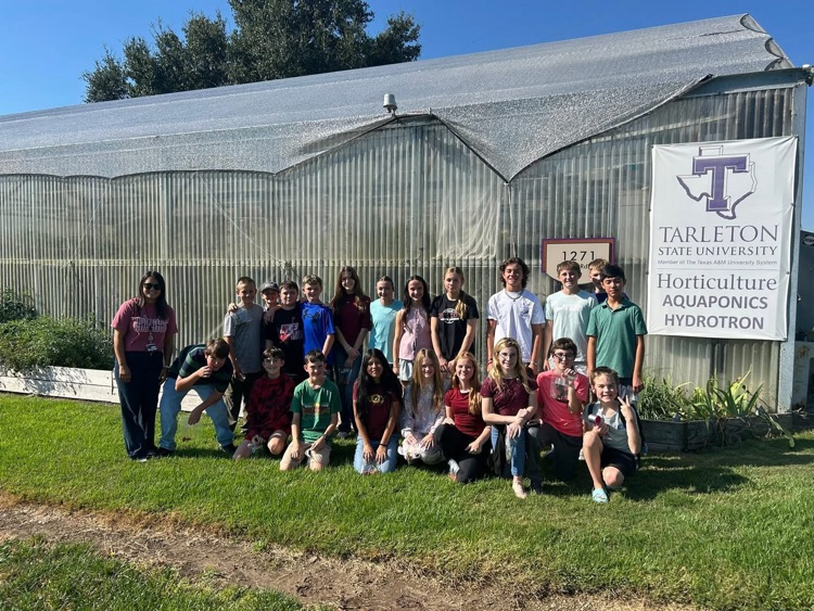 GT class in front of greenhouse at tsu