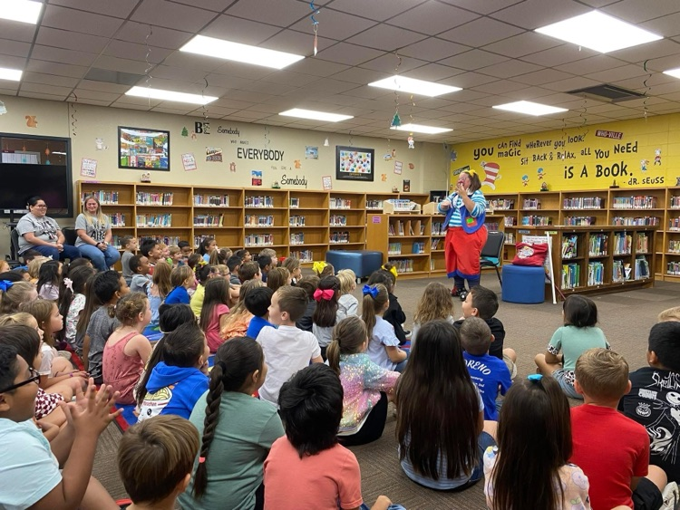 clown doing a demonstration for students in library