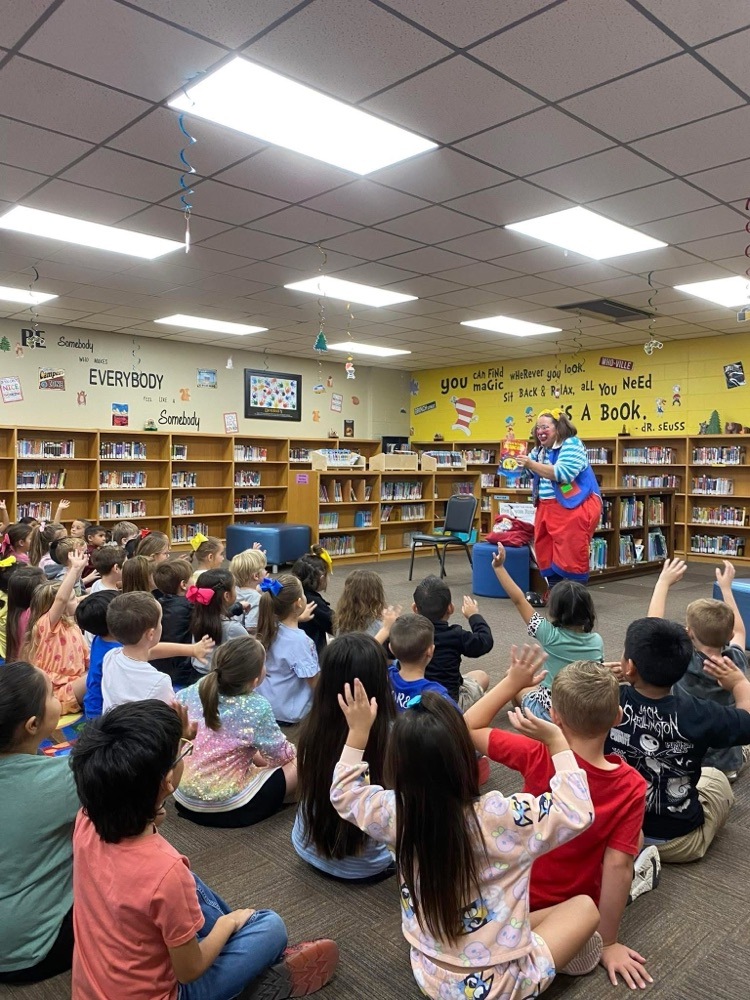 clown doing a demonstration for students in library