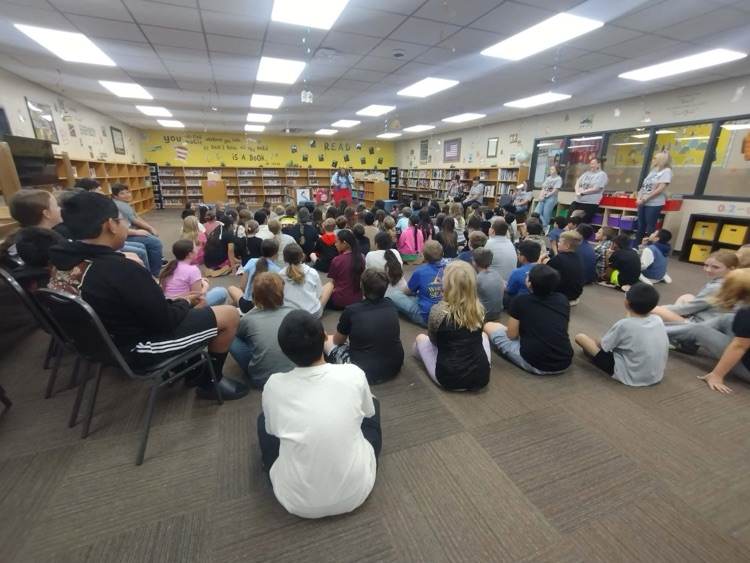 clown doing a demonstration for students in library