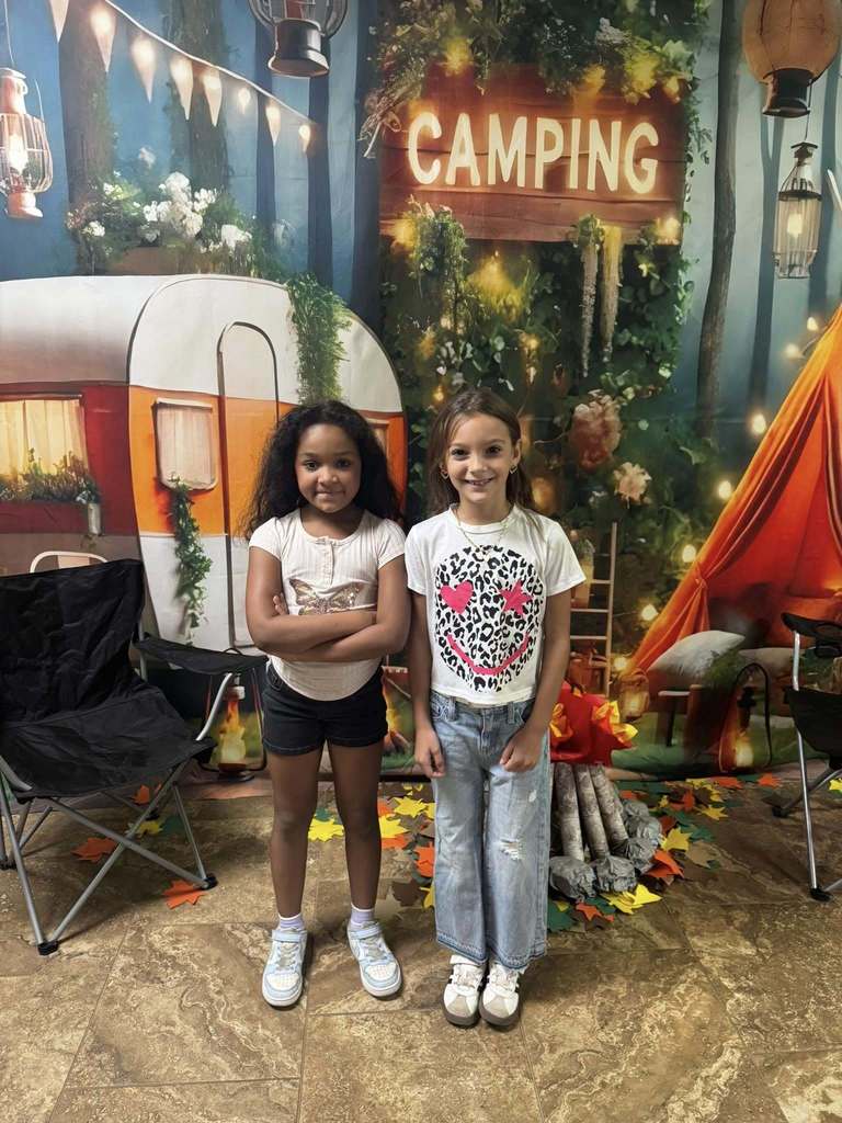 two happy campers of the week standing in front of camping background