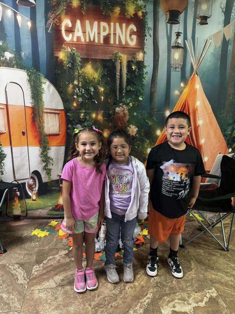 three happy campers of the week standing in front of camping background