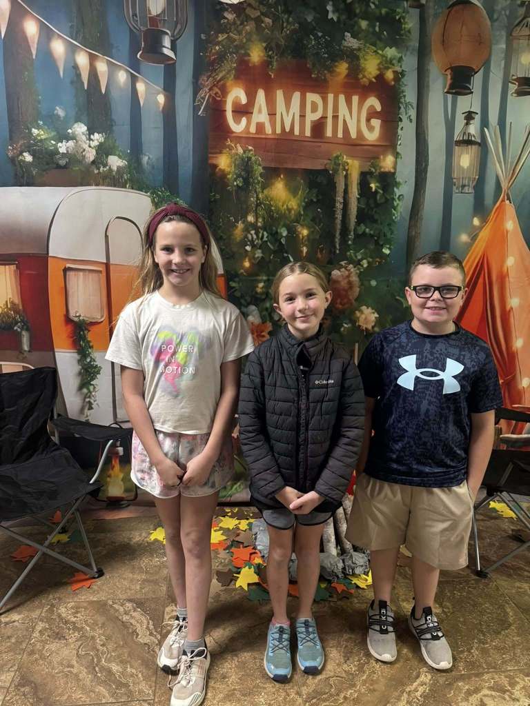 three happy campers of the week standing in front of camping background