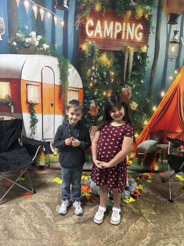 two happy campers of the week standing in front of camping background