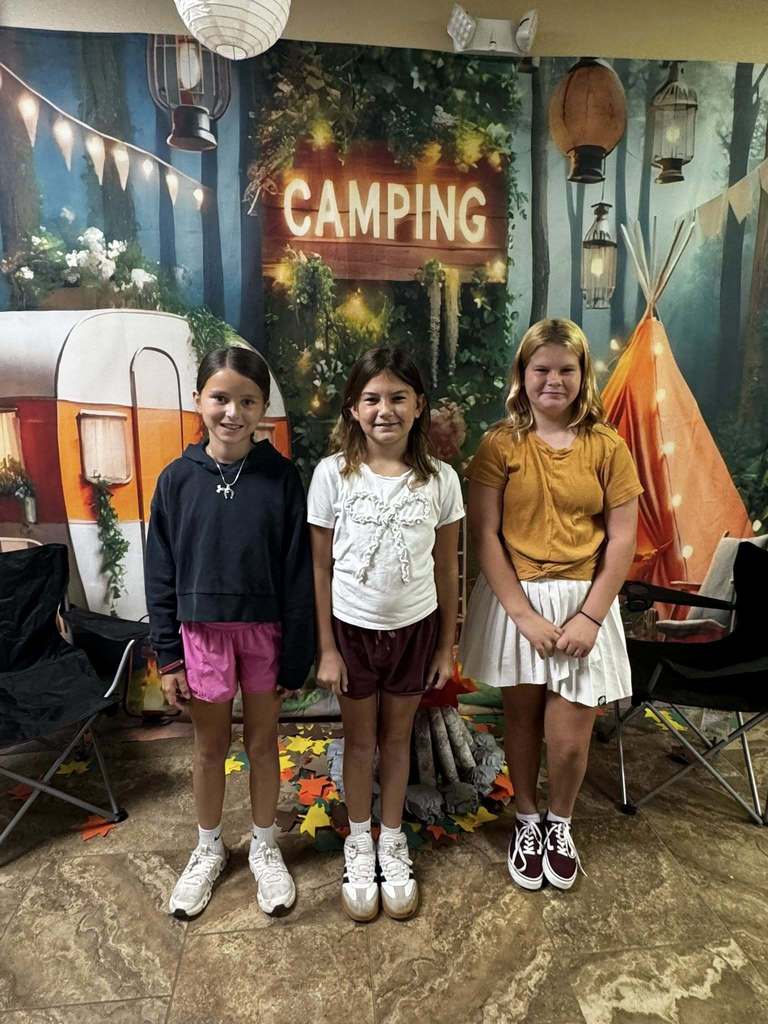 three happy campers of the week standing in front of camping background
