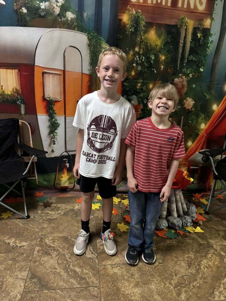 two student campers of the week in front of campsite backdrop