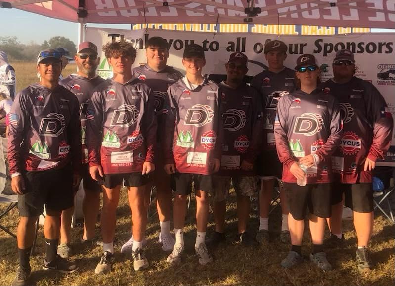 bass club group picture in front of sponsor banner