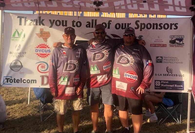 bass club sponsors in front of bass club banner