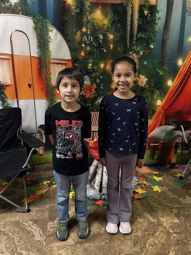 two happy campers of the week standing in front of camping background